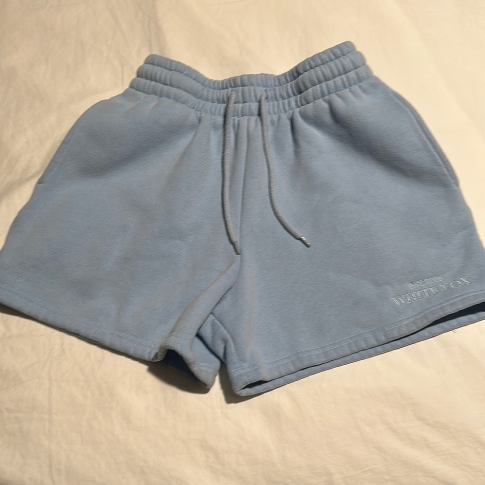 White fox, blue sweatshorts